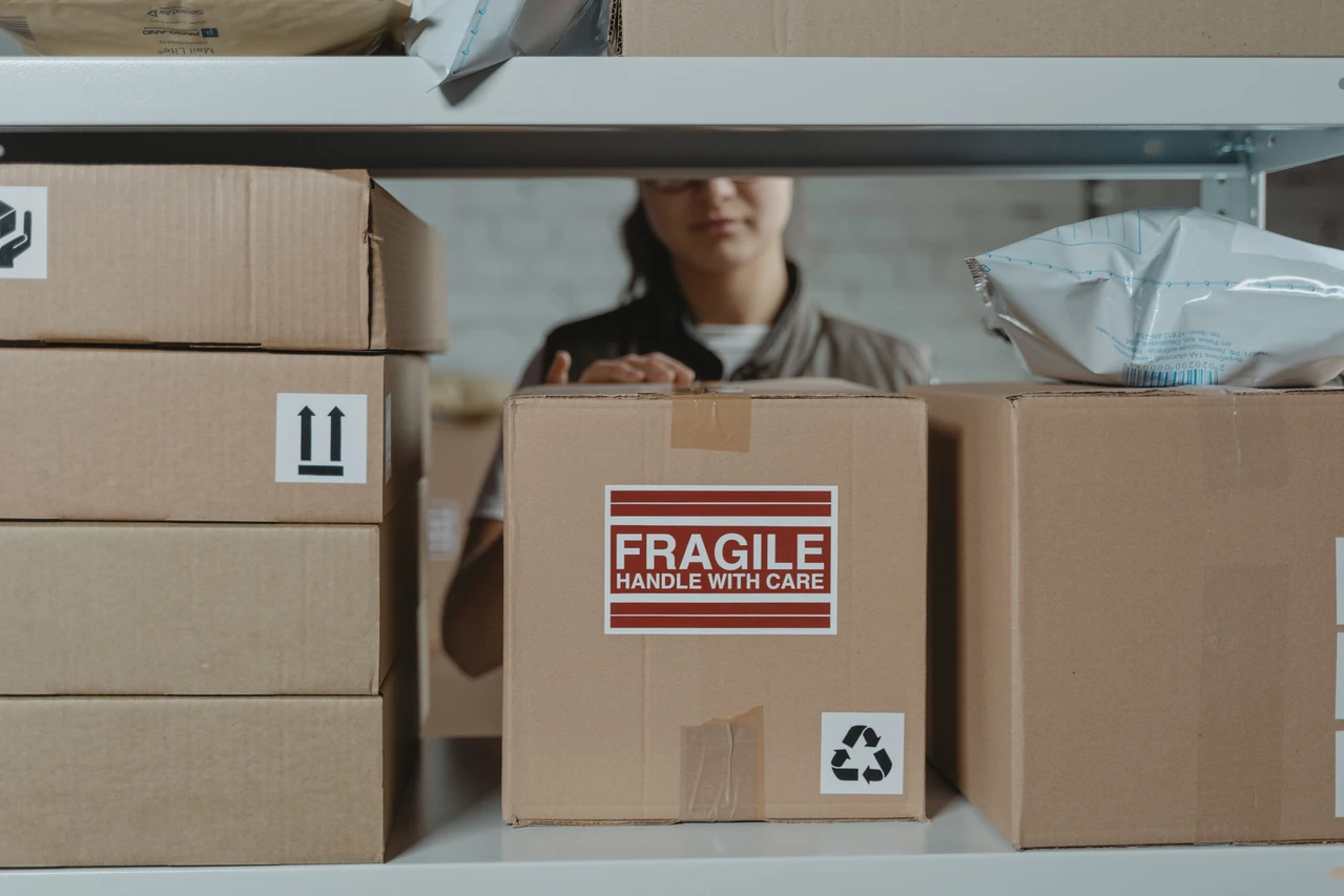 Warehouse employee checking parcels on shelving