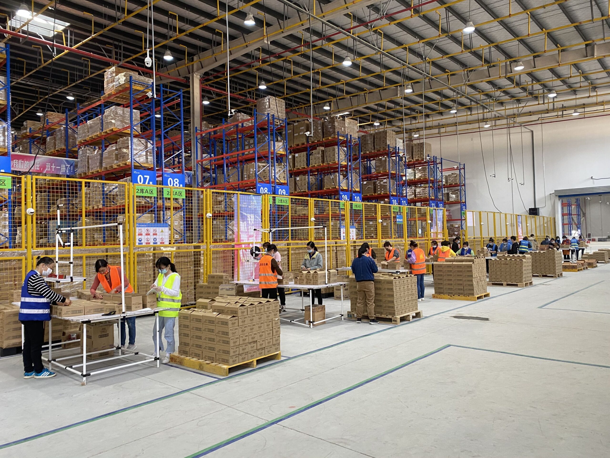 Warehouse staff preparing cartons at packing stations in China