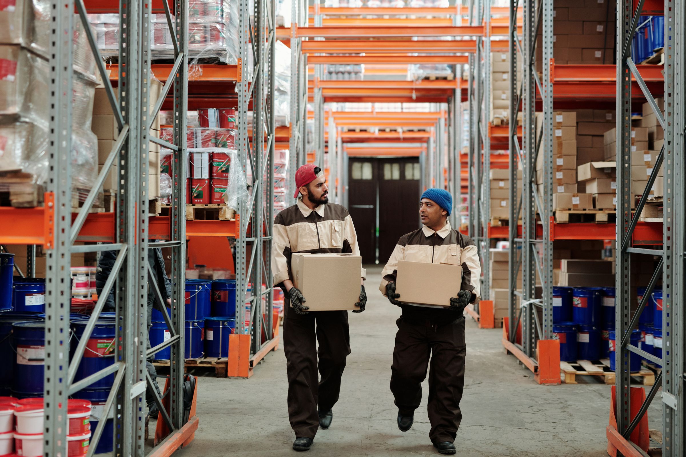 Warehouse workers moving supplier cartons