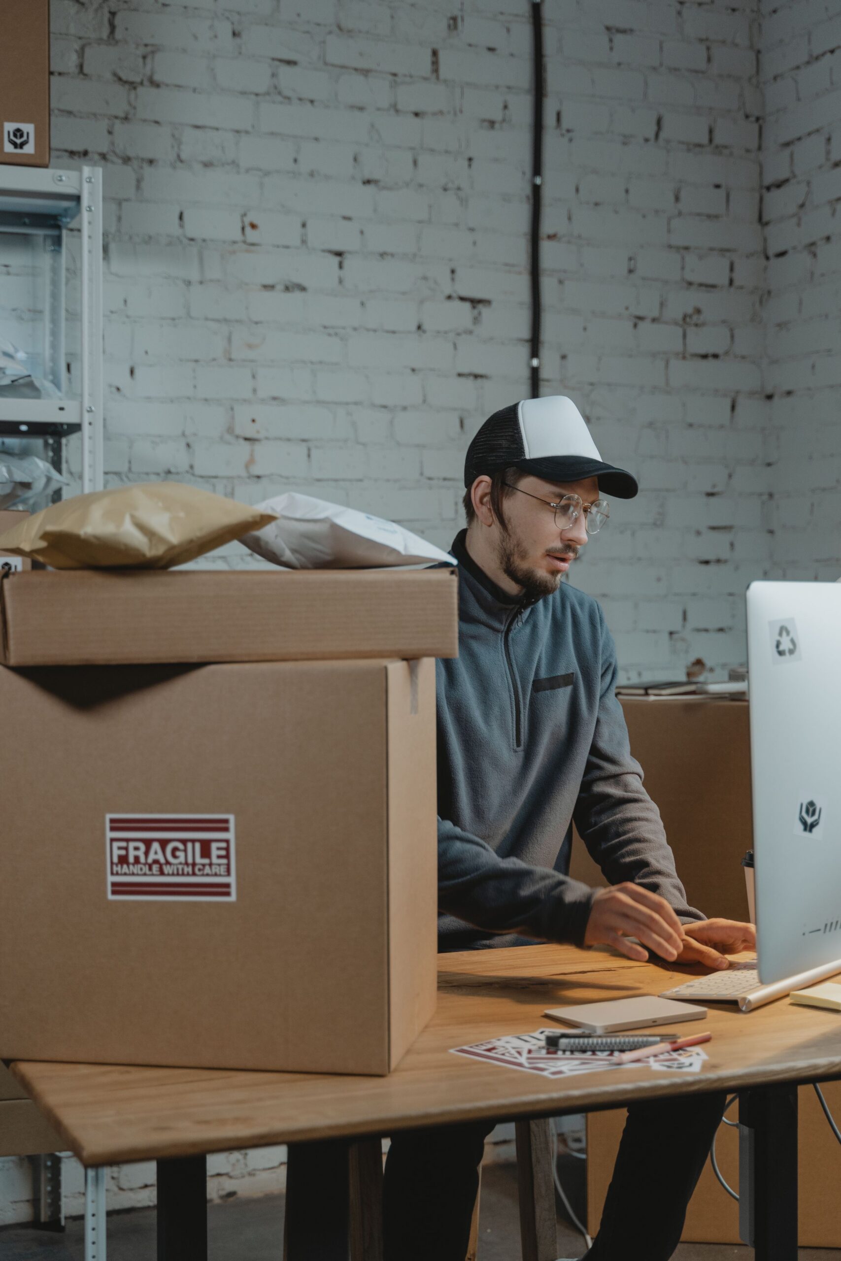 Order processing at a computer beside parcels